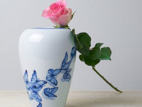 Handbeschilderde delfts blauwe urn beschilderd met vlinders en een roze roos erbij Heinen Delfts Blauw